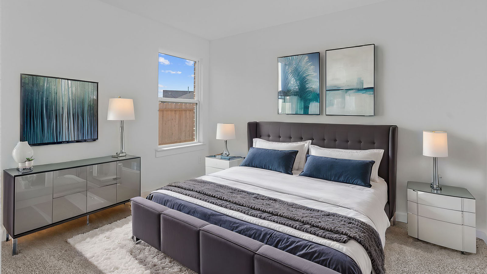 Comfortable guest bedroom featuring neutral-toned walls, carpeted flooring, and a separate closet.
