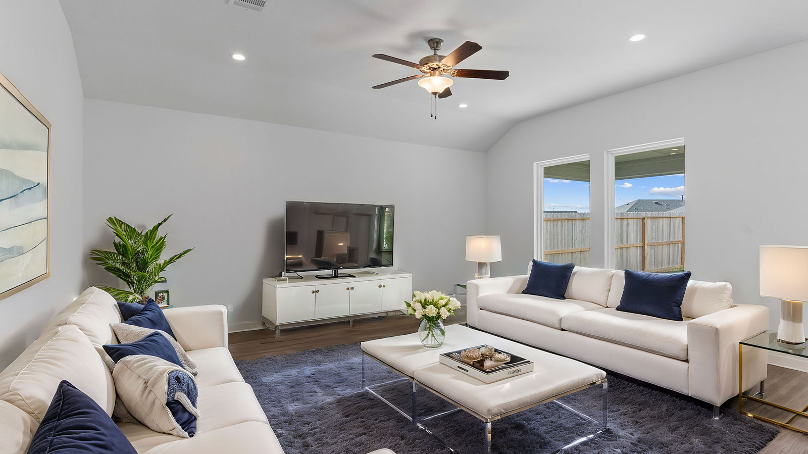 A well-organized living room that includes a kitchen and dining area, creating a warm and welcoming environment for gatherings.