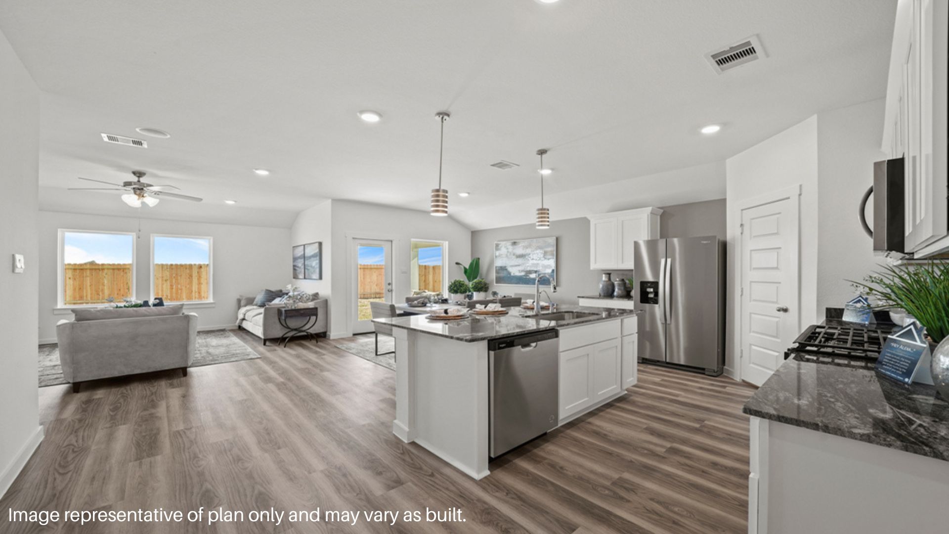 Open concept living and dining space with vinyl flooring.