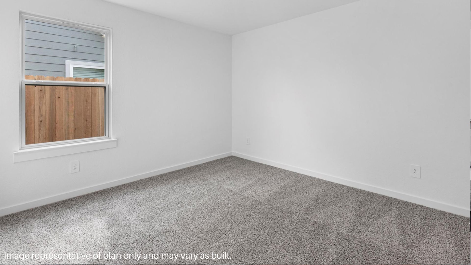 Secondary bedroom with carpet flooring and a bright window.