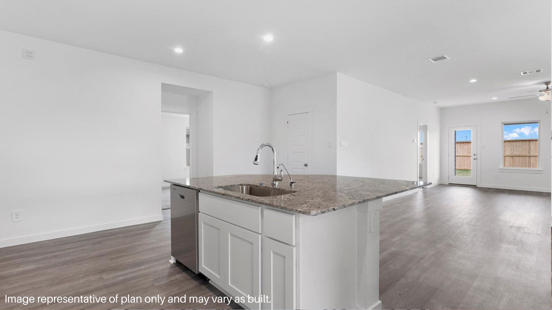 Spacious family room with vinyl flooring and bright windows.