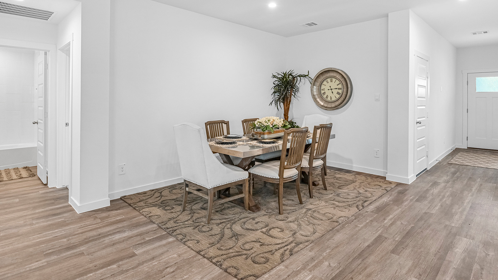 Spacious open concept dining area with vinyl wood flooring