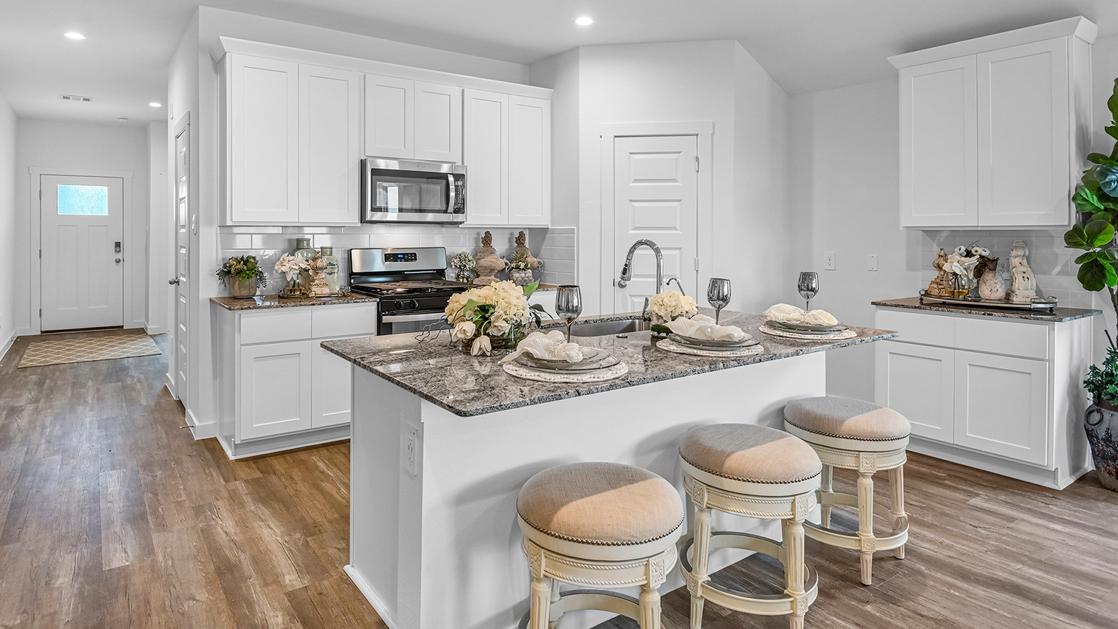 Kitchen adorned with painted cabinets seamlessly integrated into an open dining area layout.
