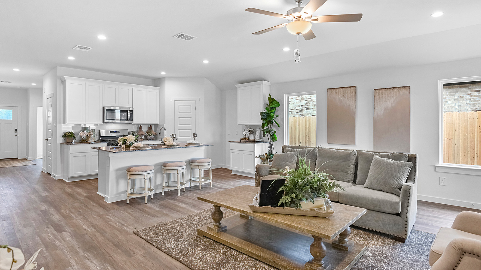 A well-organized living room that includes a kitchen and dining area, creating a warm and welcoming environment for gatherings.