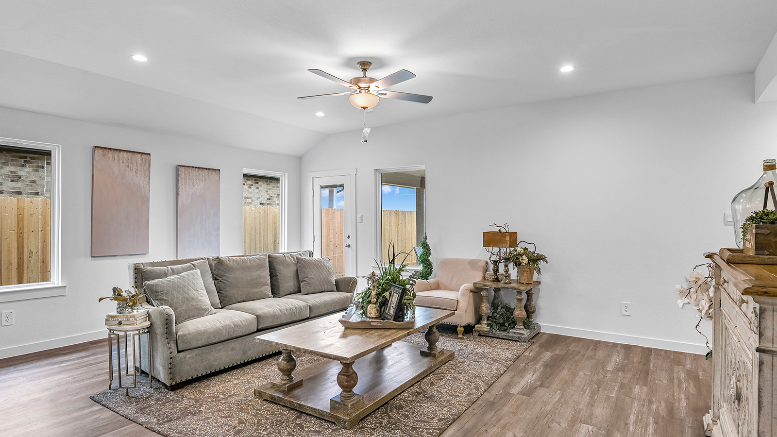 A cozy living room featuring a comfortable couch, a stylish coffee table, and an elegant painting on the wall.