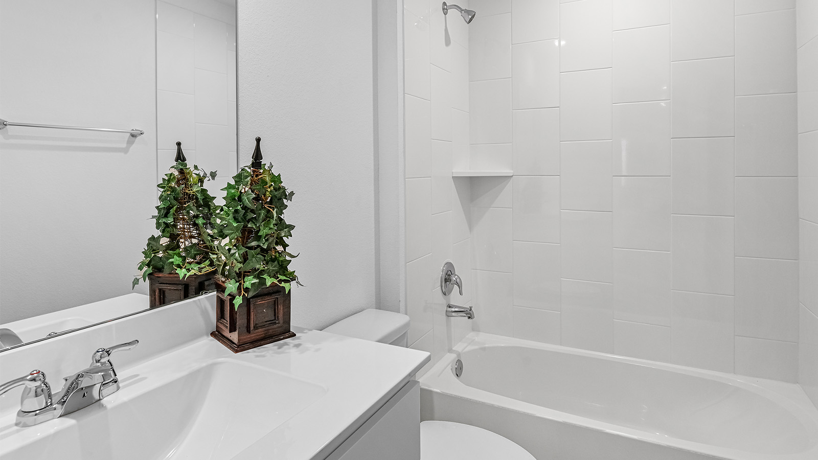 A well-designed bathroom equipped with quartz countertops, a standing tub, and a single vanity.