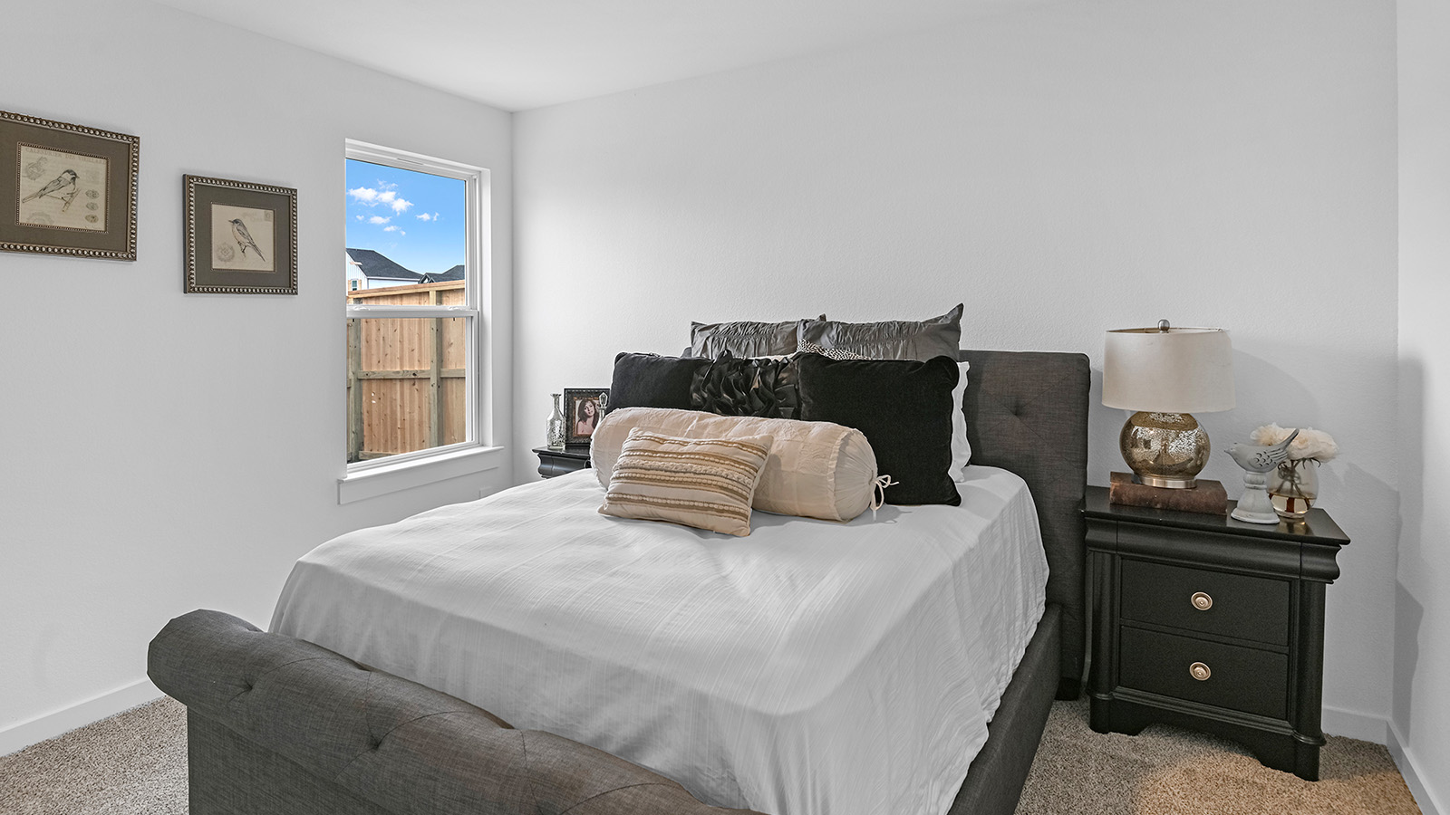A third bedroom with neutral walls, plush carpet flooring and a separate closet.