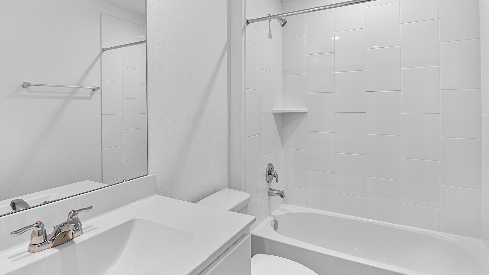 A well-designed bathroom equipped with quartz countertops, a standing tub, and a single vanity.