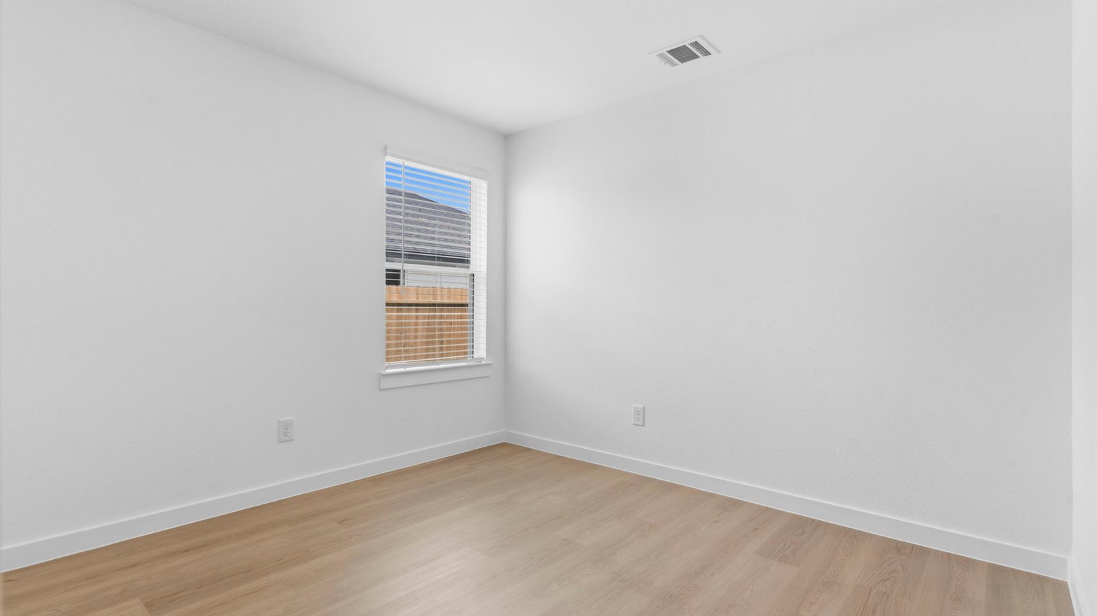 A second bedroom with neutral walls, plush carpet flooring and a separate closet.
