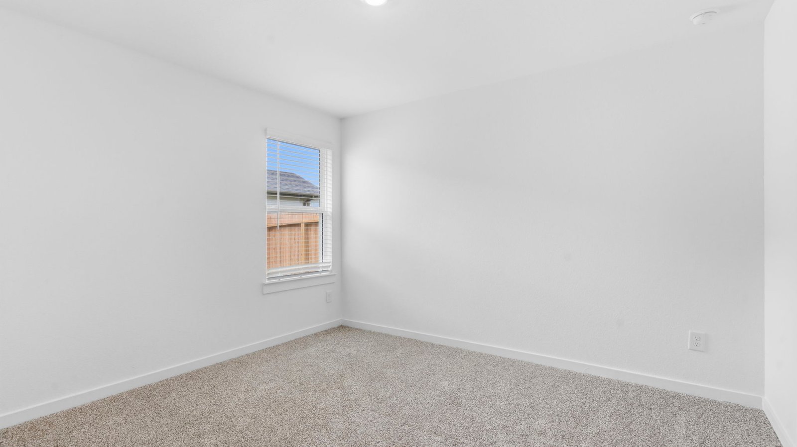 A third bedroom with neutral walls, plush carpet flooring and a separate closet.