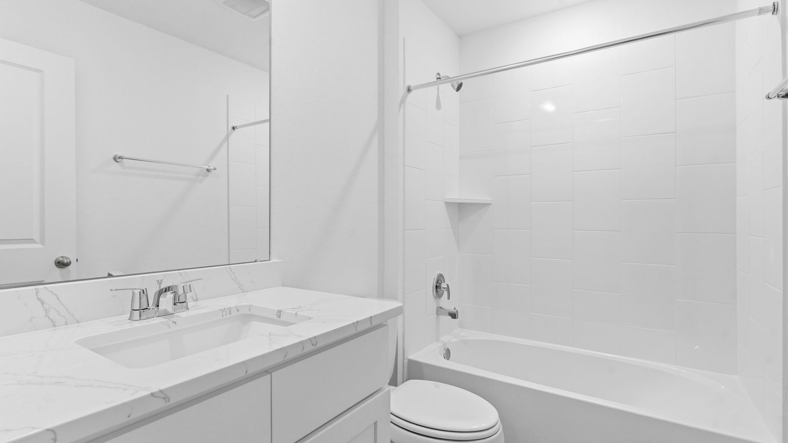 A well-designed bathroom equipped with quartz countertops, a standing tub, and a single vanity.