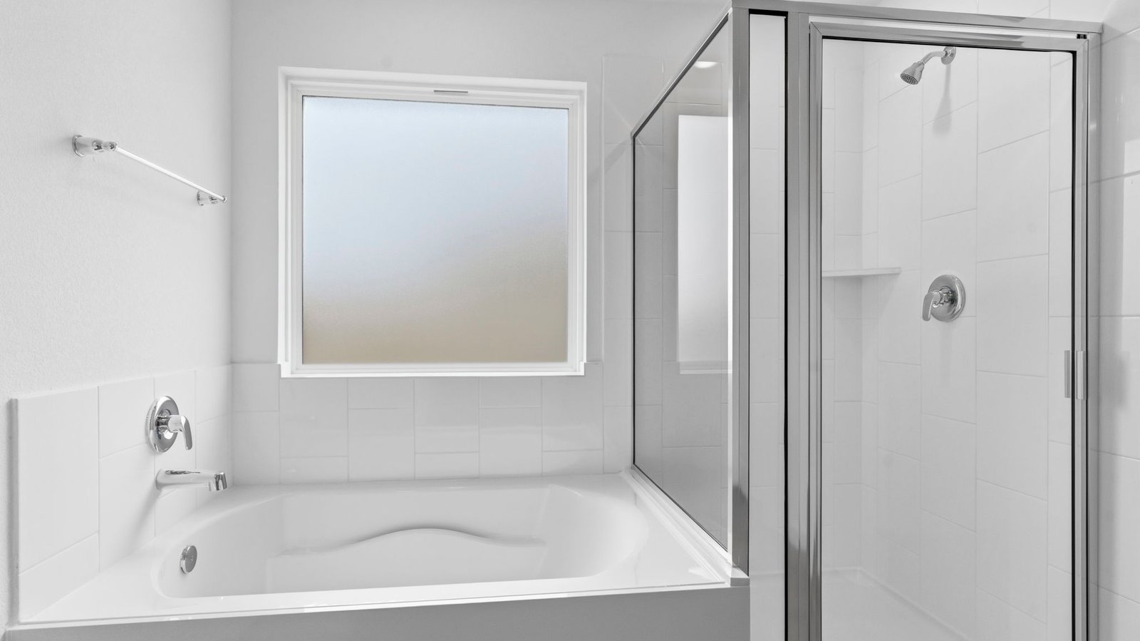 Primary bathroom with a glass-enclosed standing shower and separate soaking tub.