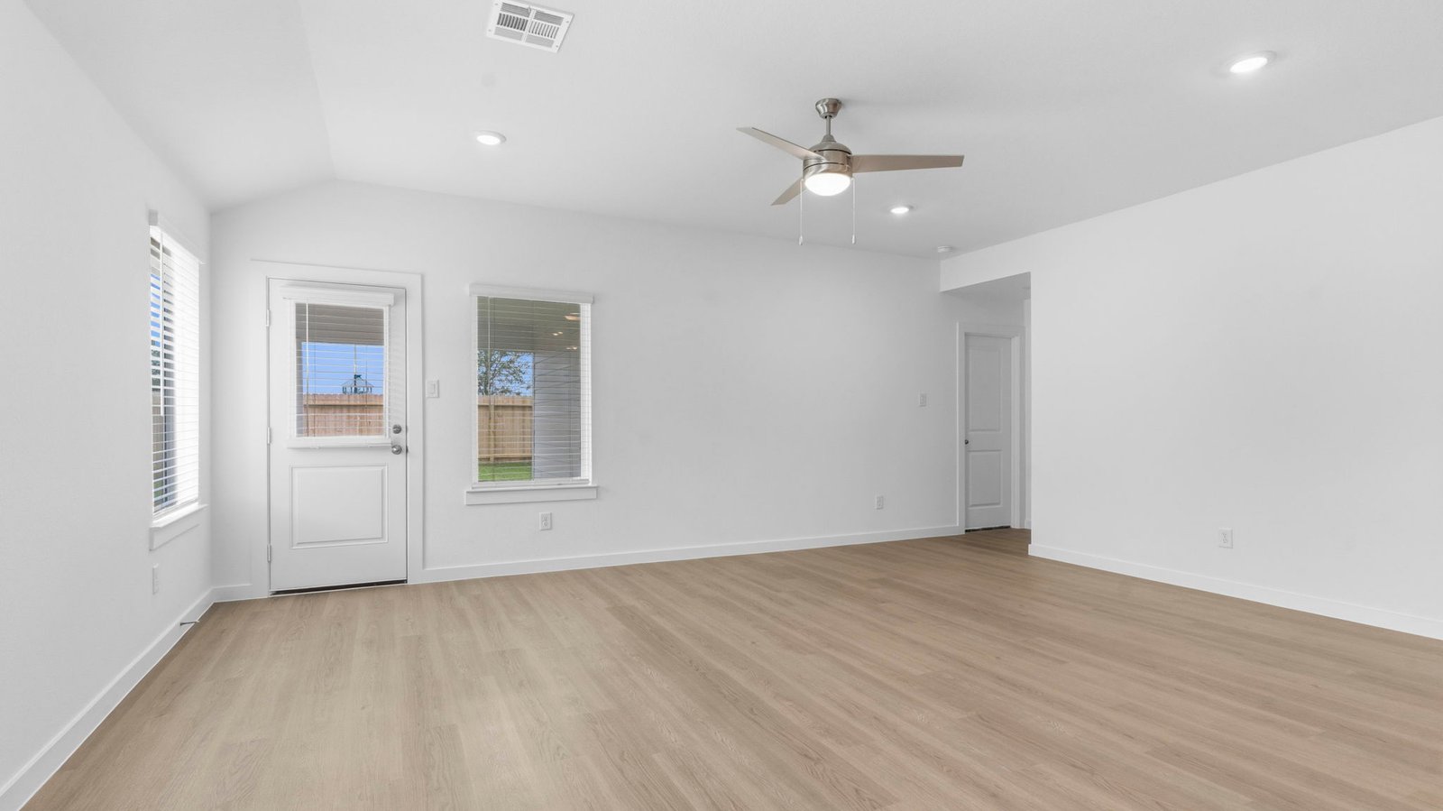 A well-organized living room that includes a kitchen and dining area, creating a warm and welcoming environment for gatherings.