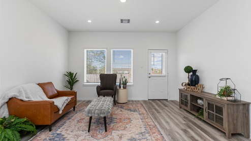Living room with two windows and a back patio door