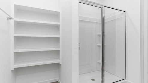 Primary bathroom stand alone shower and open shelving