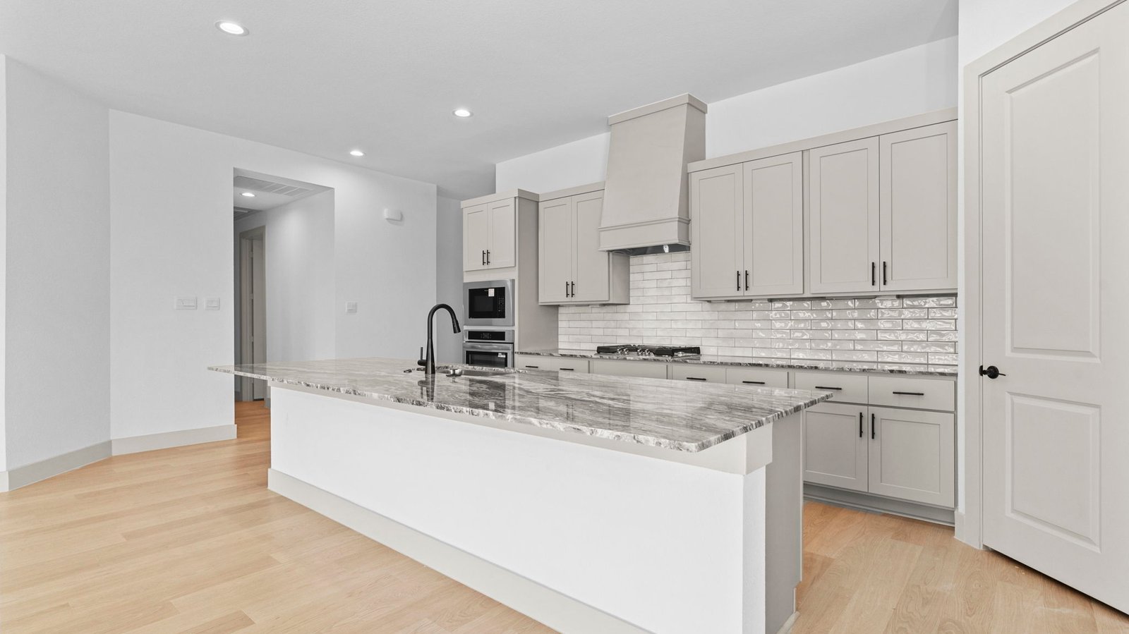 .kitchen with large island and walk in pantry