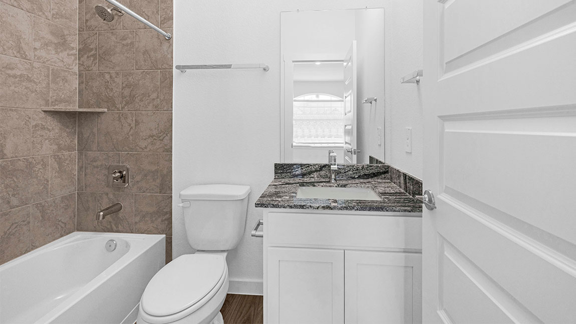 bathroom with a vanity sink, toilet and shower