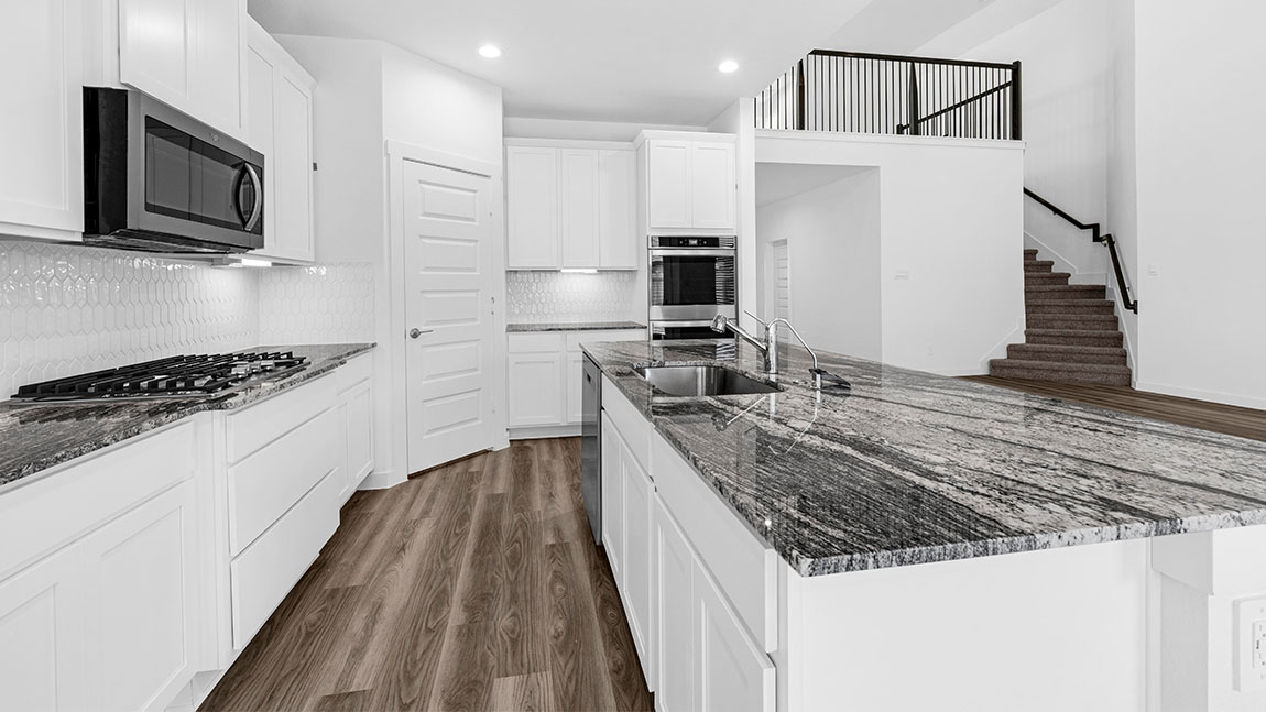 kitchen with white cabinetry, large island, and stainless steel appliances