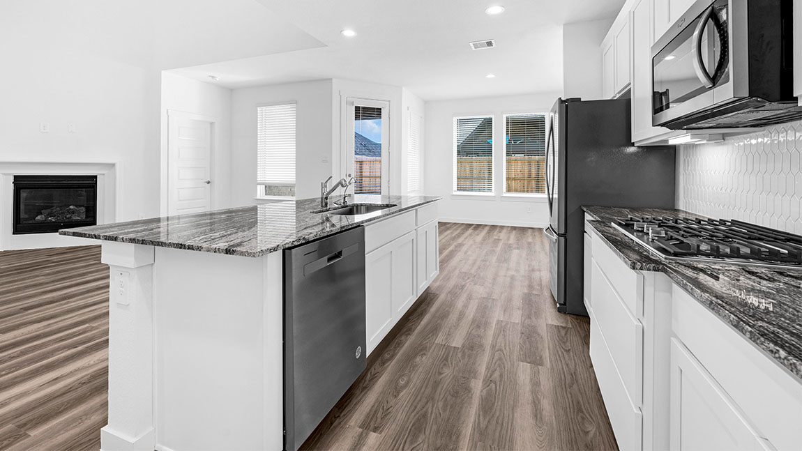 kitchen with white cabinetry, large island, and stainless steel appliances