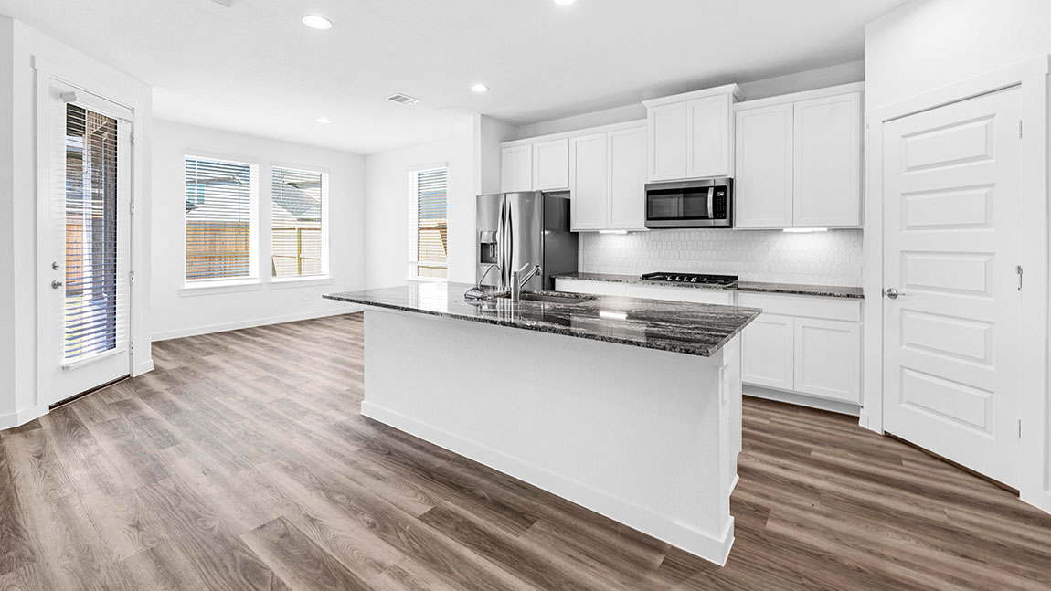 kitchen with white cabinetry, large island, and stainless steel appliances