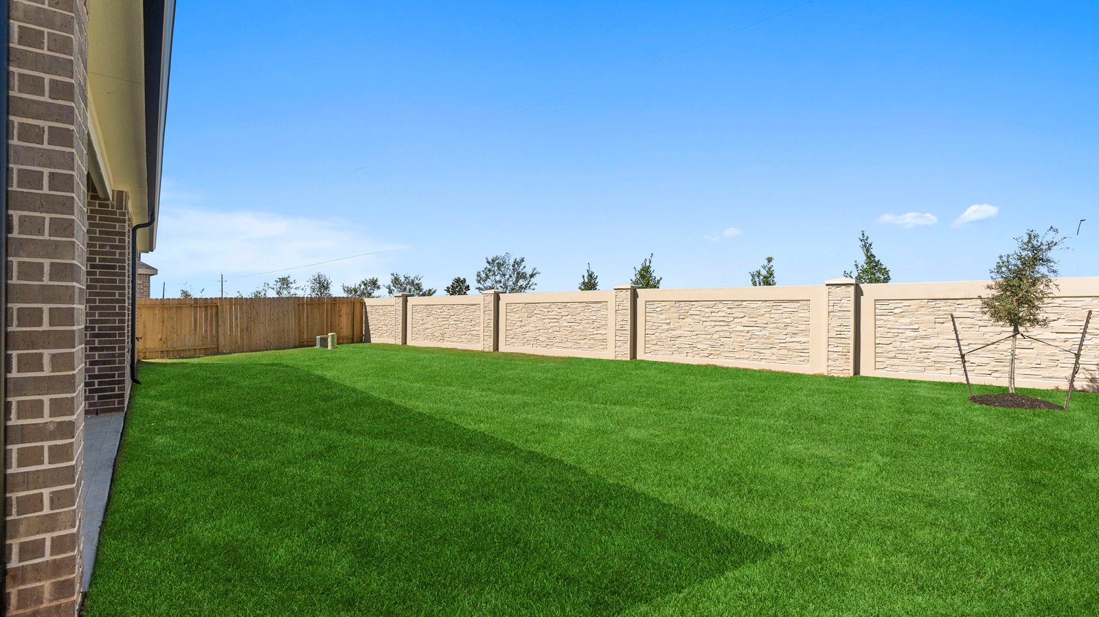 Large fenced-in backyard with a covered patio, perfect for outdoor entertaining.