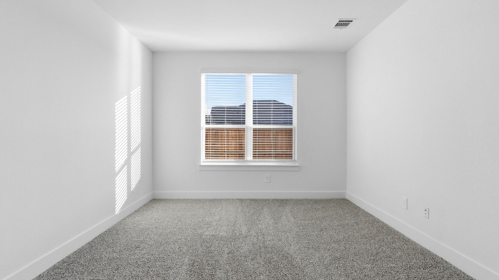 A second bedroom with neutral walls, plush carpet flooring and a separate closet.