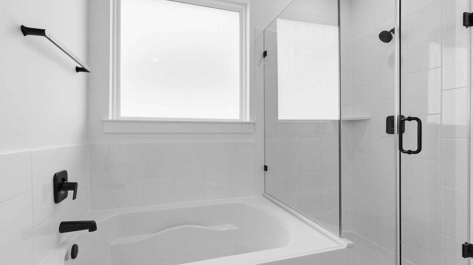 Primary bathroom with a glass-enclosed standing shower and separate soaking tub.