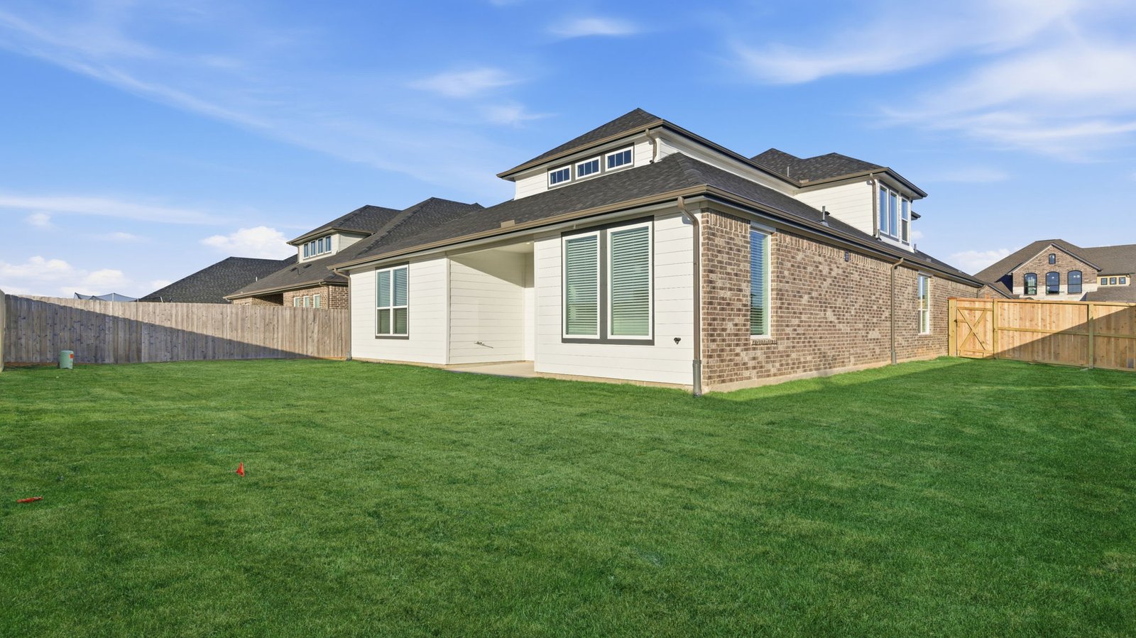 Large fenced-in backyard with a covered patio, perfect for outdoor entertaining.