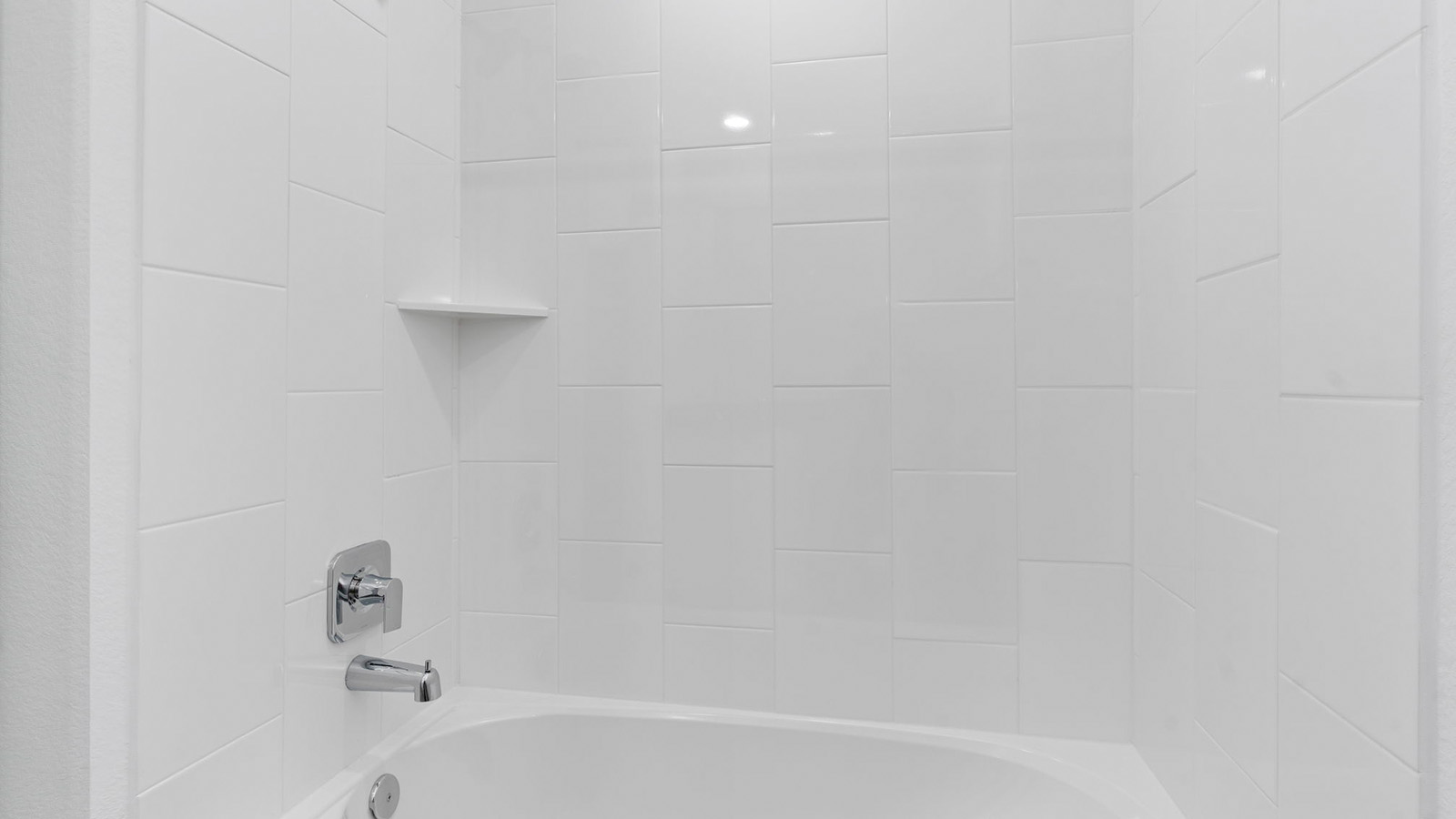 secondary bathroom with a tub and shower