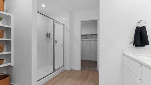 Primary bathroom with open shelving and shower