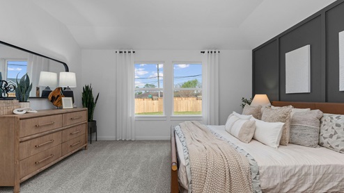 Primary bedroom with two large windows