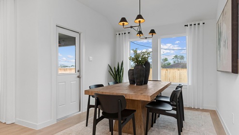 Dining room with two large windows and back patio door