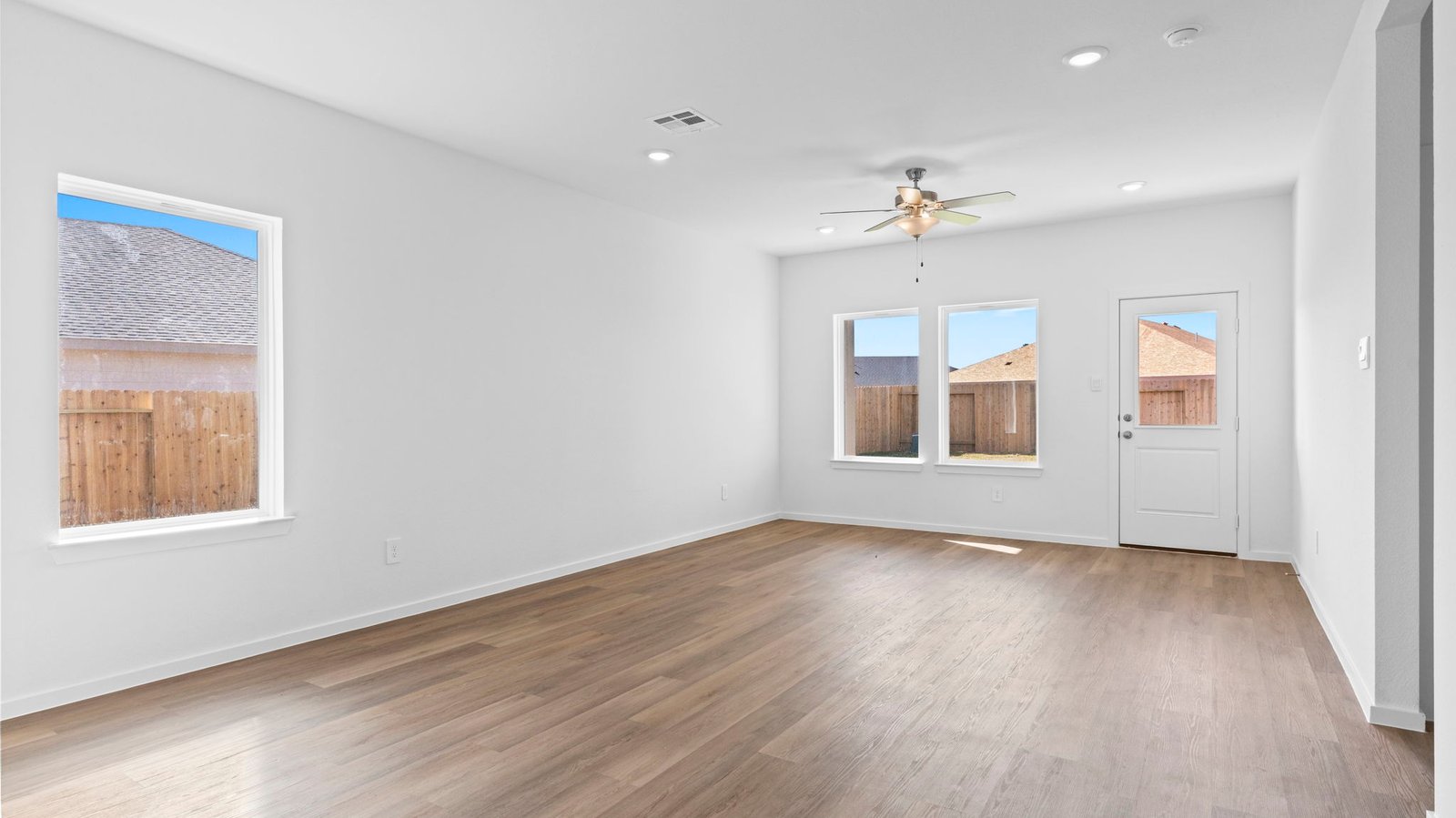 open concept dining room and living room with multiple windows