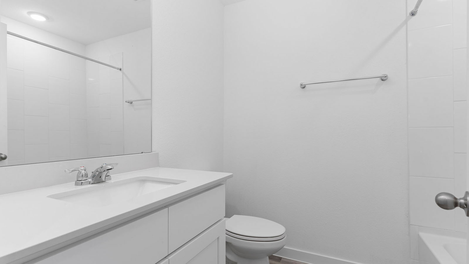 Secondary bathroom with one sink and shower and bathtub combo