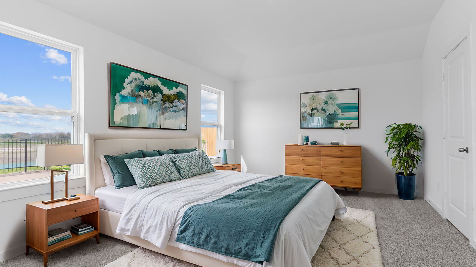 Primary bedroom with two large windows