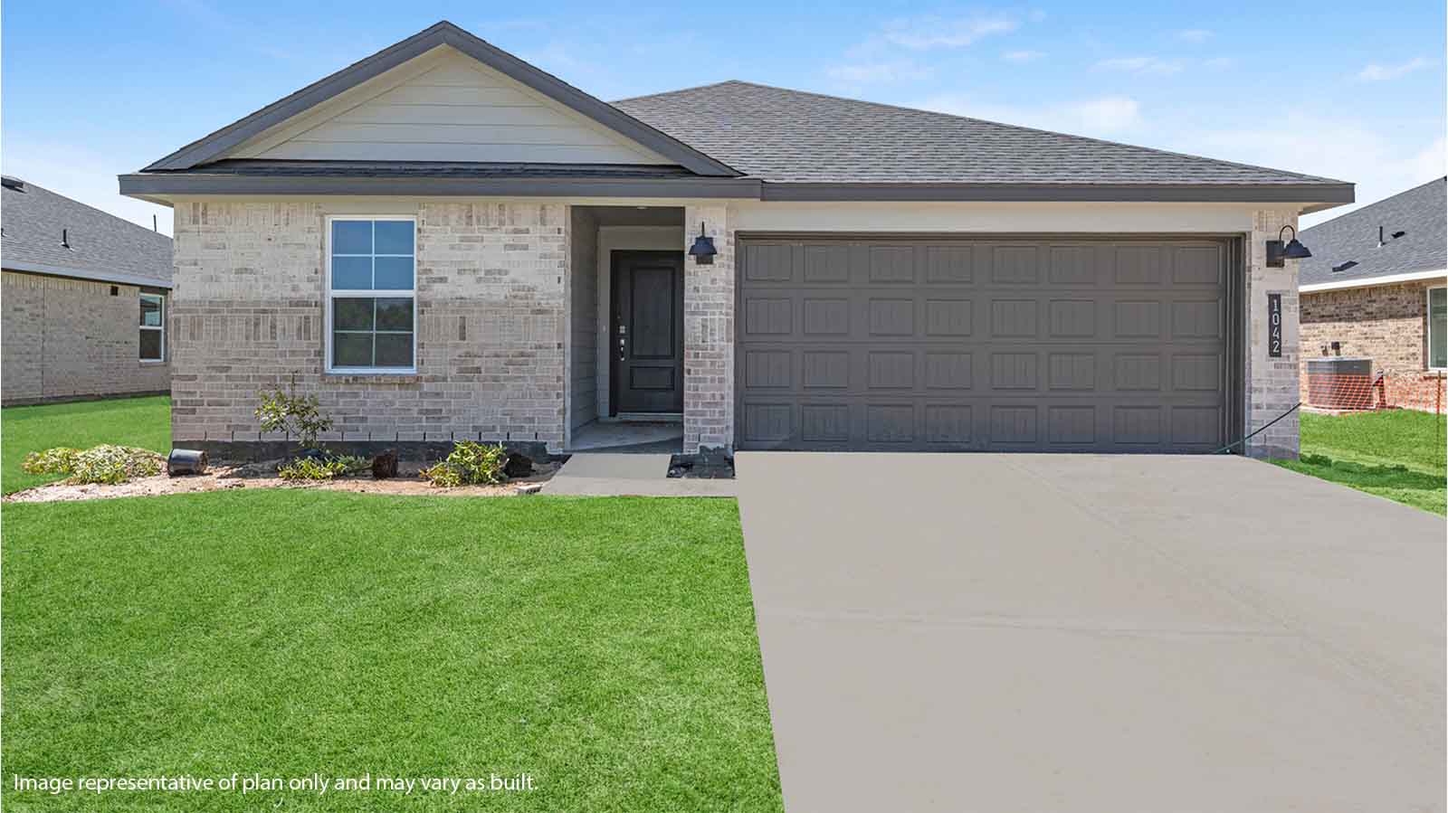 Single story brick home with a two car garage