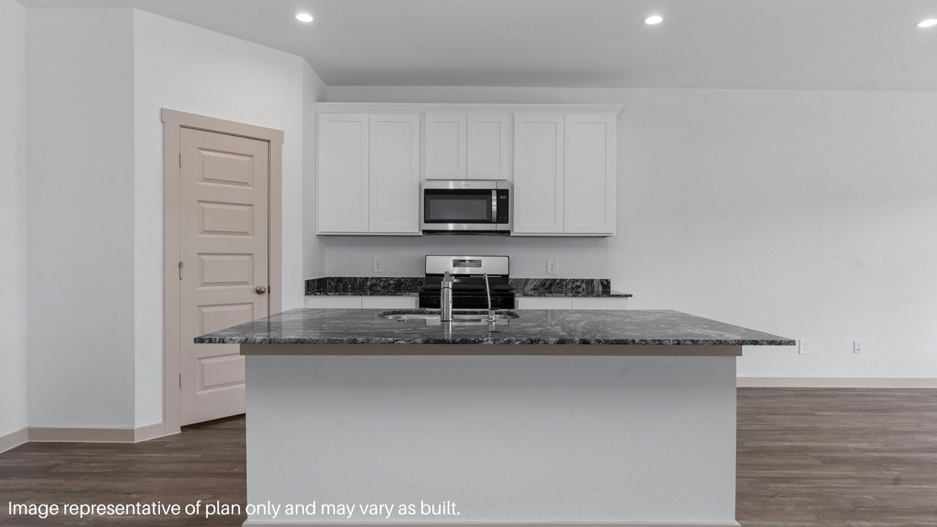 Kitchen featuring island with sink