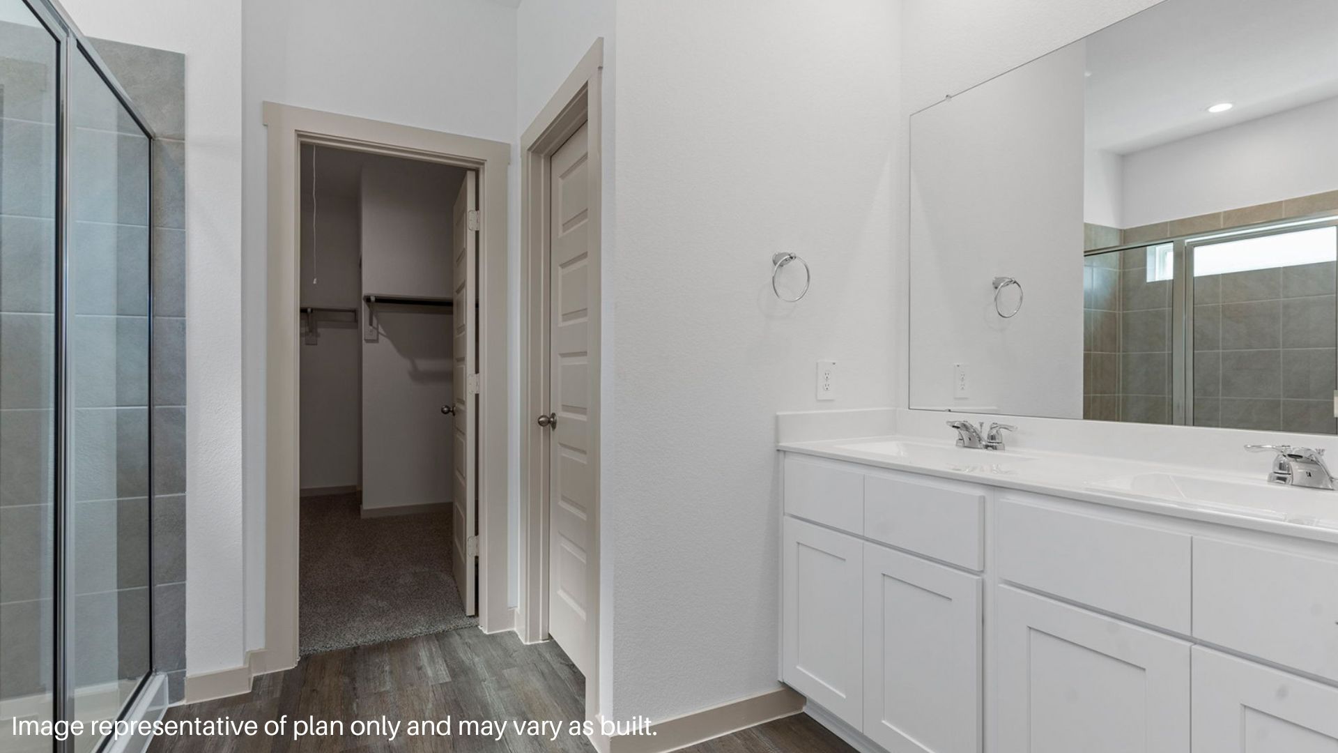 Primary bathroom with double sinks and separate tub and shower