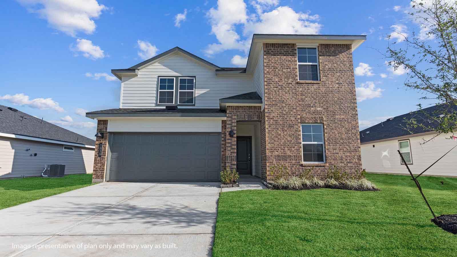 Two story brick home with a two car garage