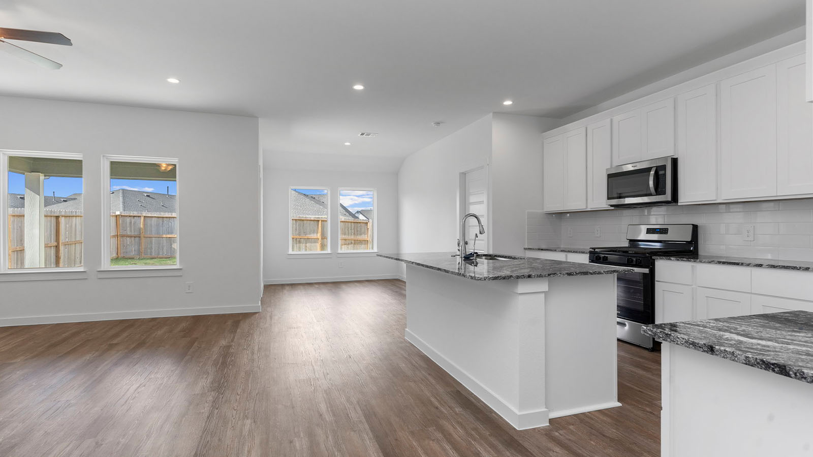 Open concept kitchen living room and dining room with large windows