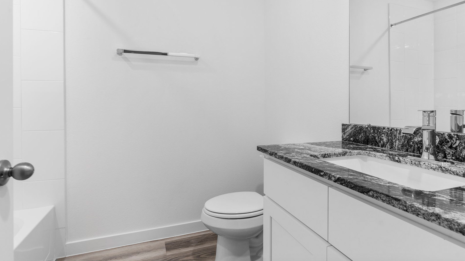 Secondary bathroom vanity with one sink and bathtub and shower