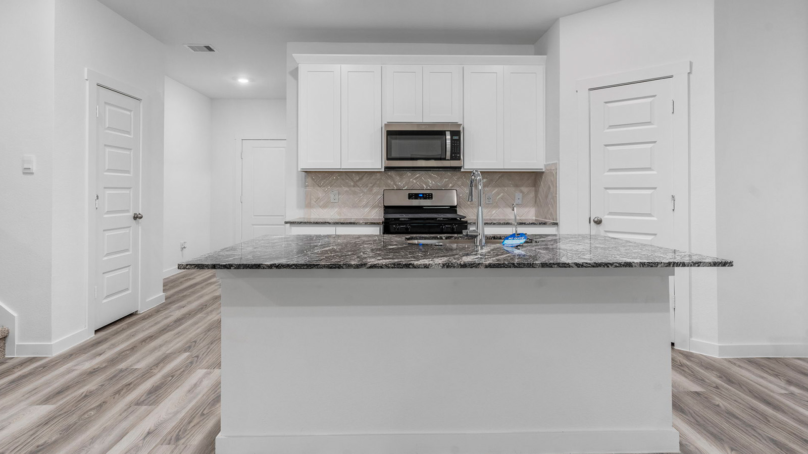 Kitchen with large island and a deep sink