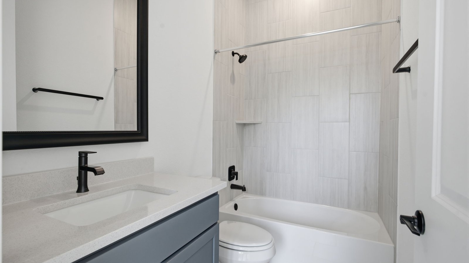 secondary bathroom with a standing tub, one sink vanity, and a window for natural lighting