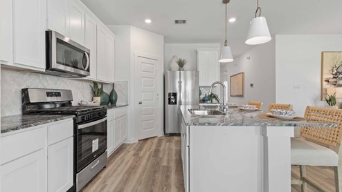 Kitchen view of the island that fits bar stools