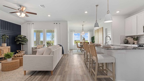 View of the entire living and kitchen area with clear view of the backyard