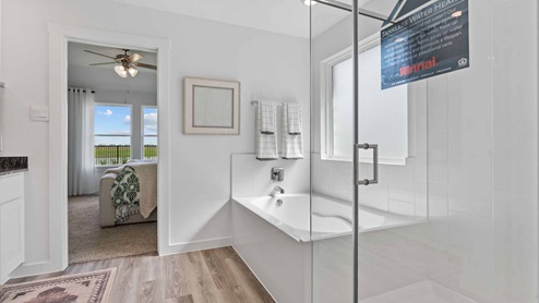 Primary bath with view of bedroom
