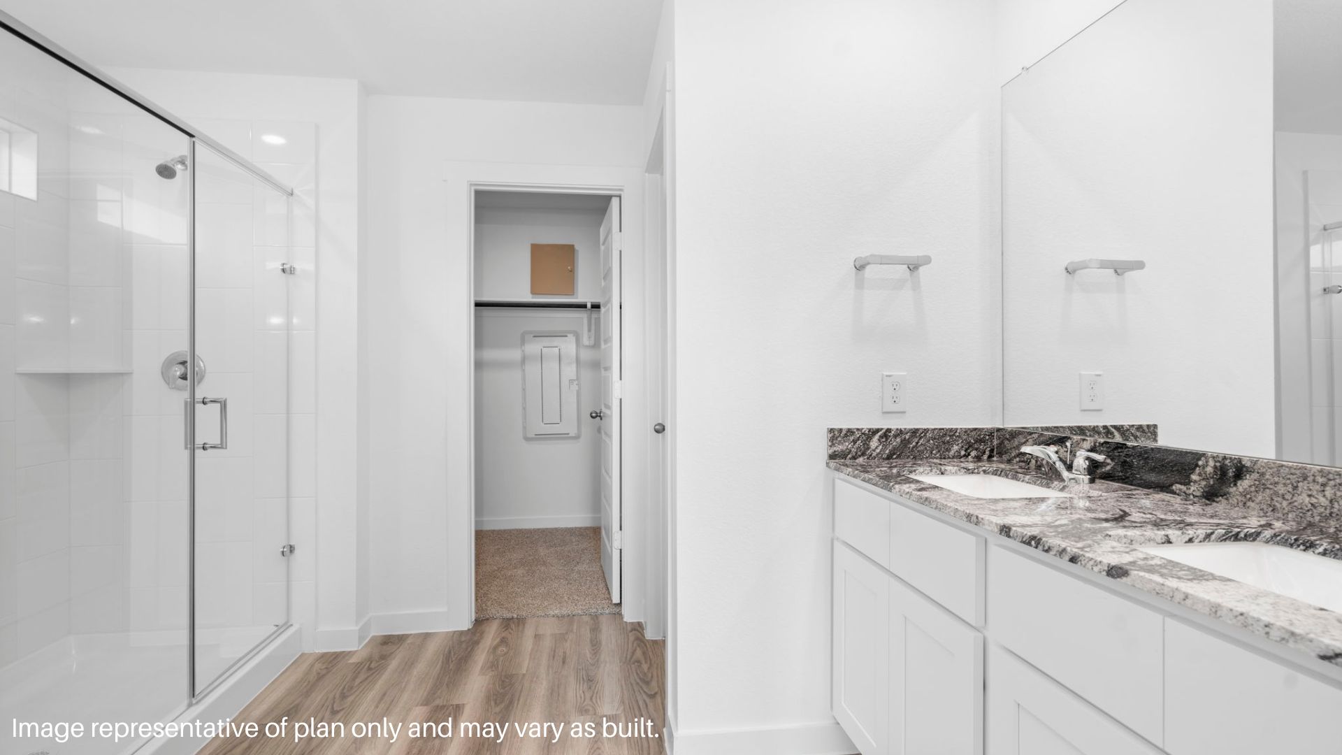primary bathroom with stand alone shower and two sinks
