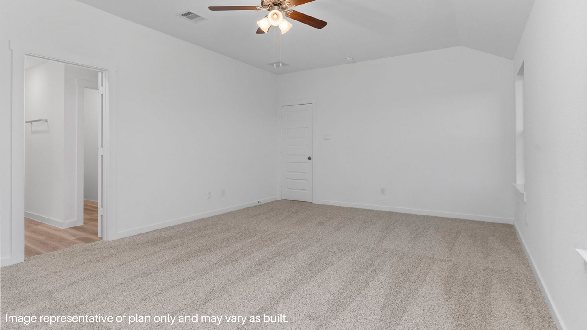 Primary bedroom with large windows.