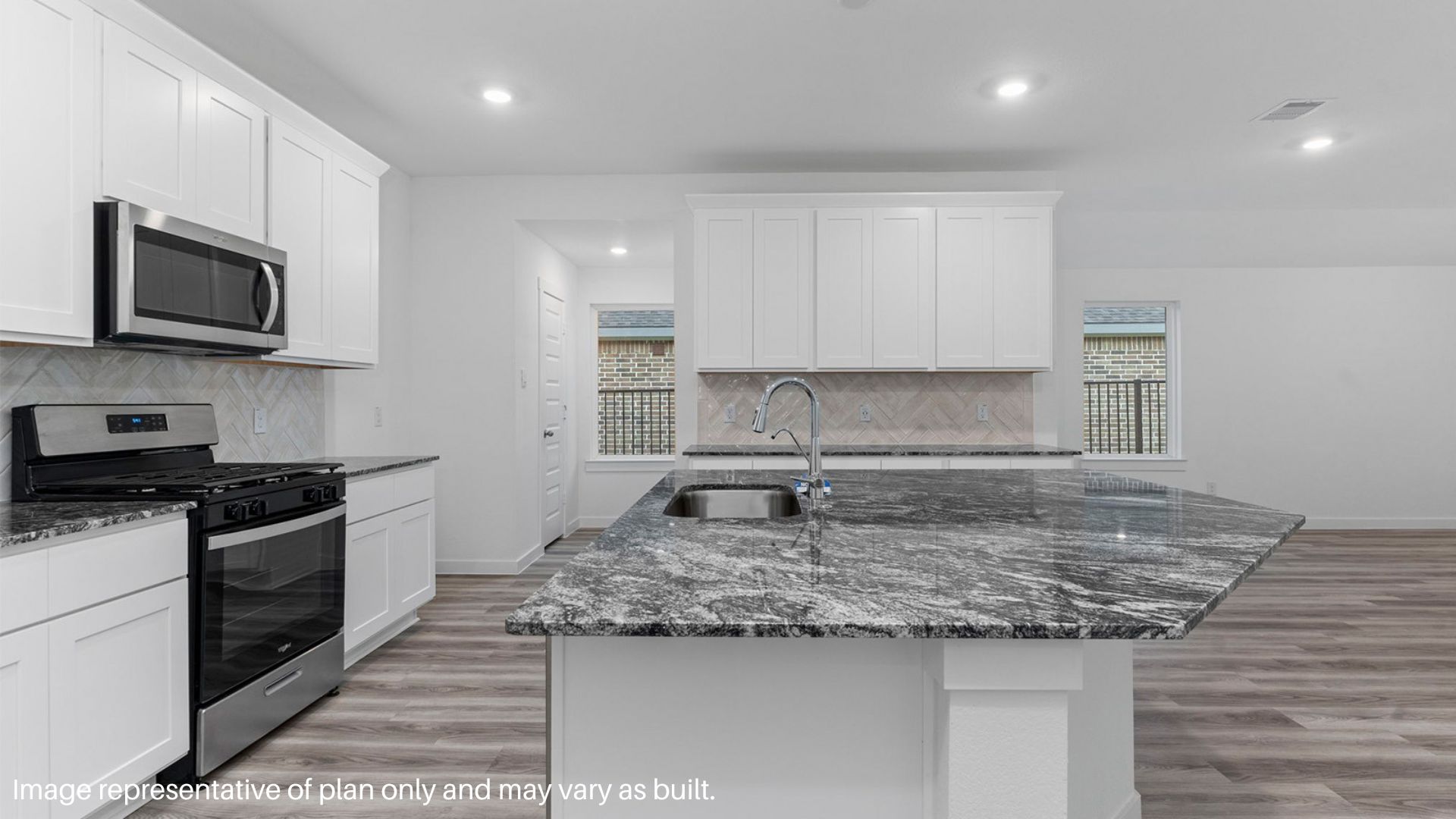 Kitchen with large island featuring a sink.