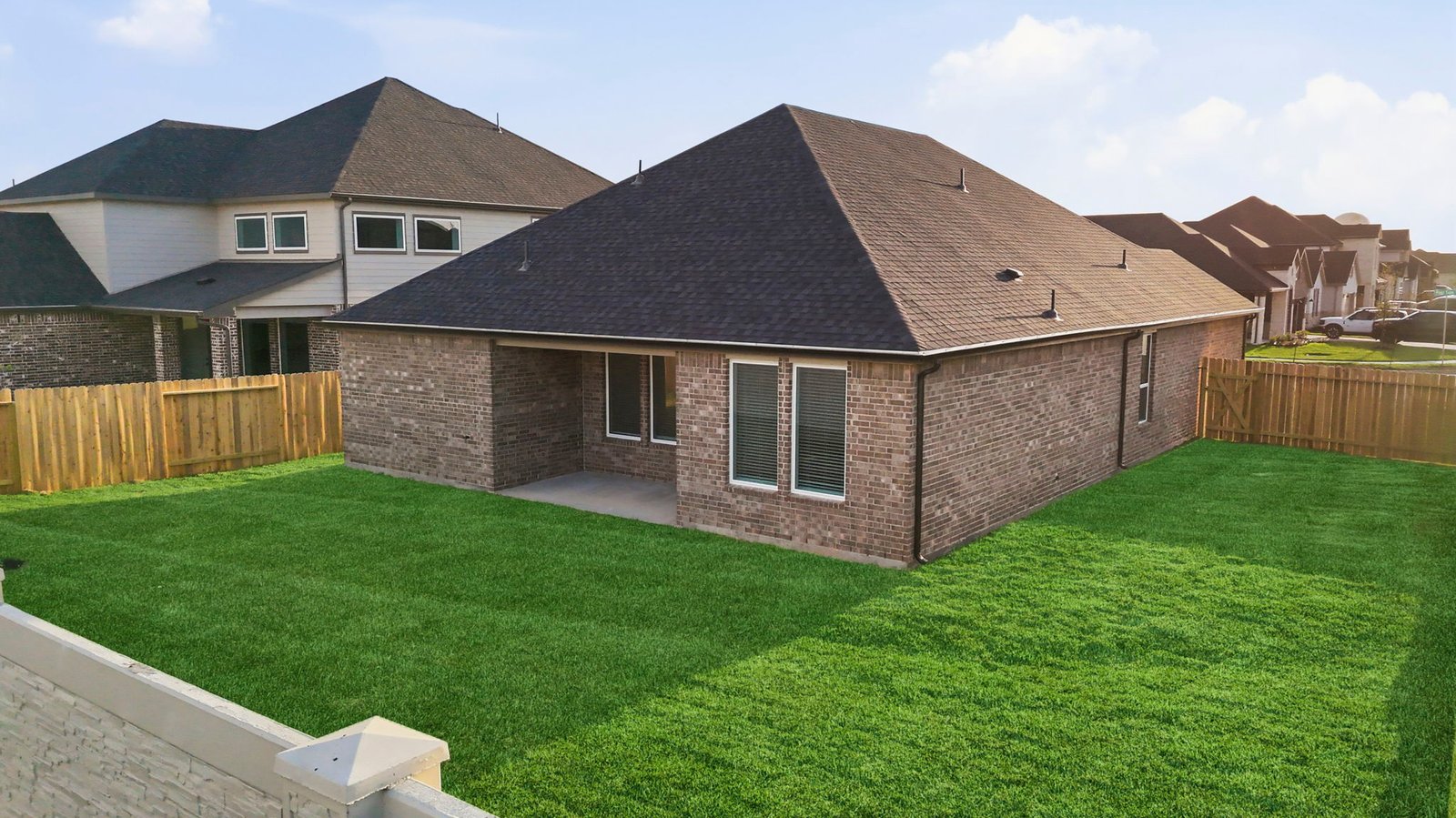 Large fenced-in backyard with a covered patio, perfect for outdoor entertaining.